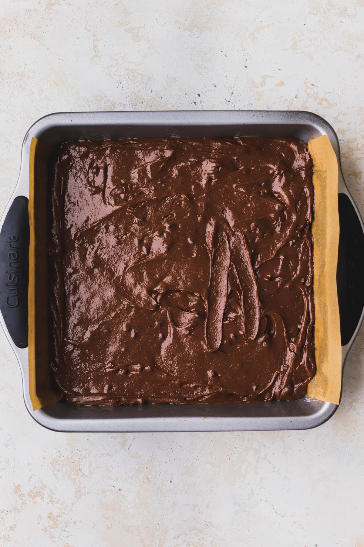 Brownie batter inside greased 8x8 baking pan. 