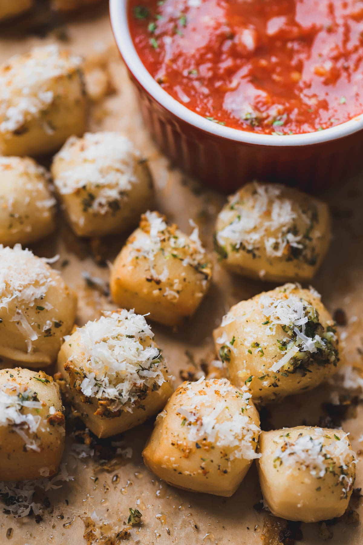 Baked parmesan bread bites topped with parmesan and served with marinara sauce.  