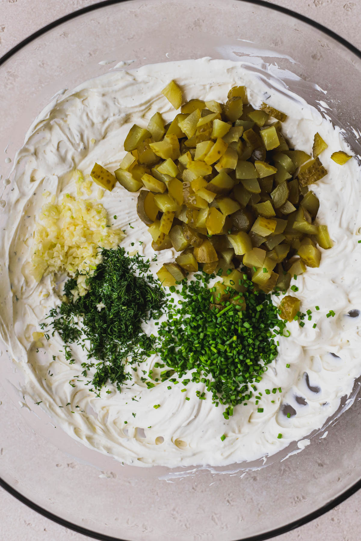 Cream cheese, sour cream, ranch dressing seasoning, chopped pickles, garlic, dill, and chives.  