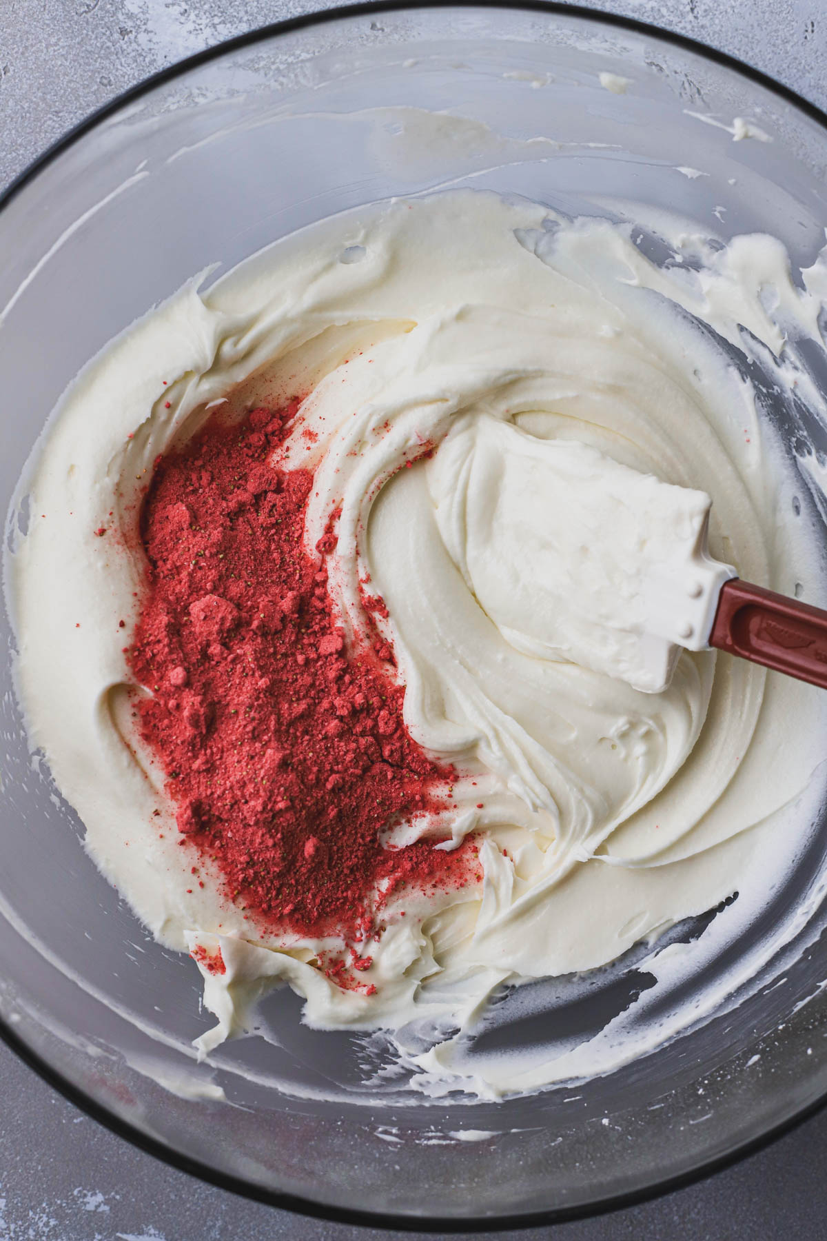 Cream cheese frosting, ground freeze dried strawberries. 