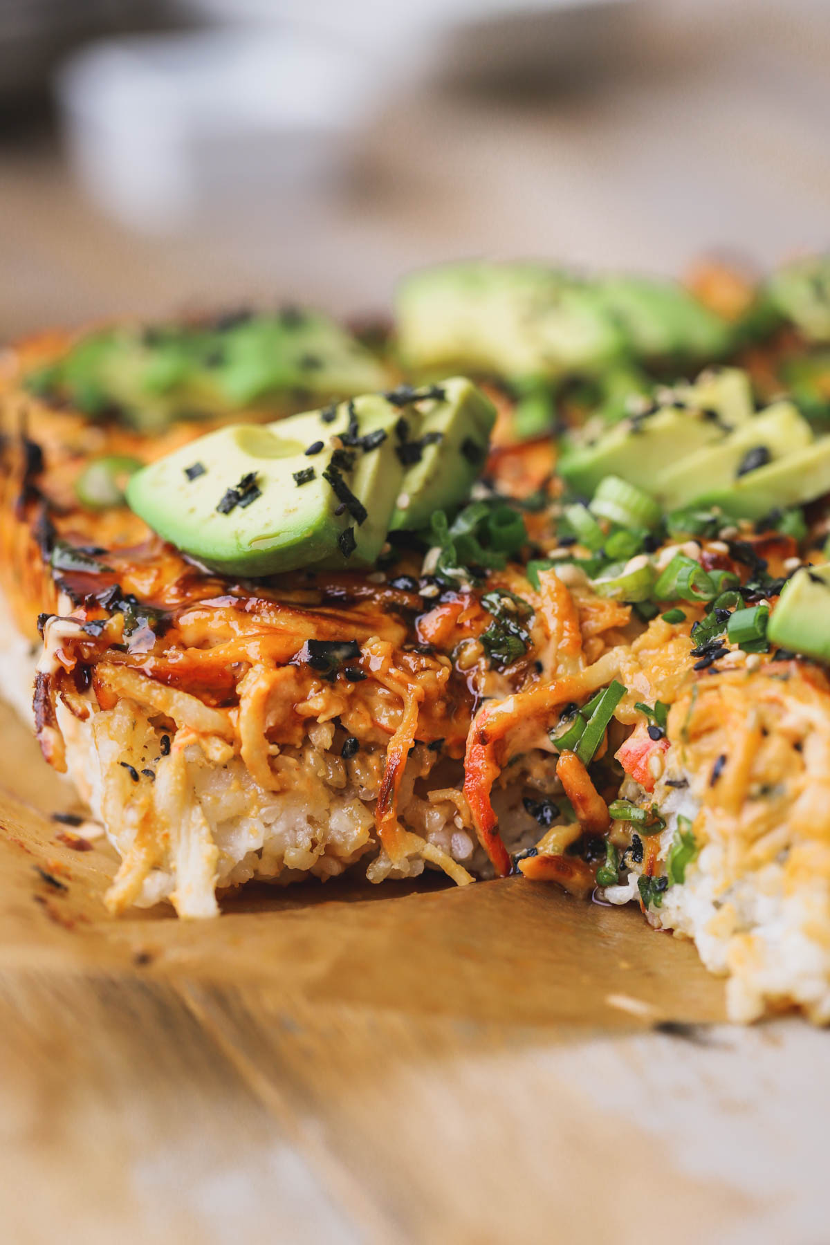 Spicy salmon sushi bake with crab meat, avocado, green onions and sesame seeds.  