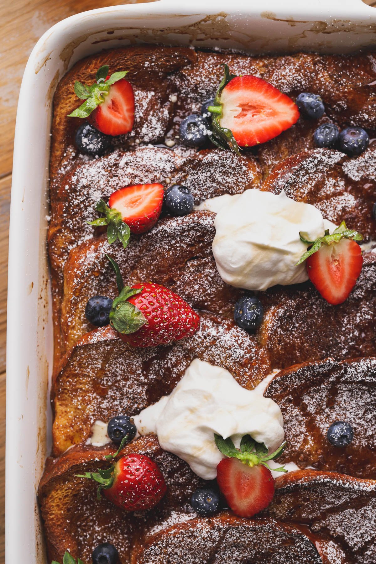 Brioche French toast bake with cinnamon sugar, fresh berries and whipped cream. 