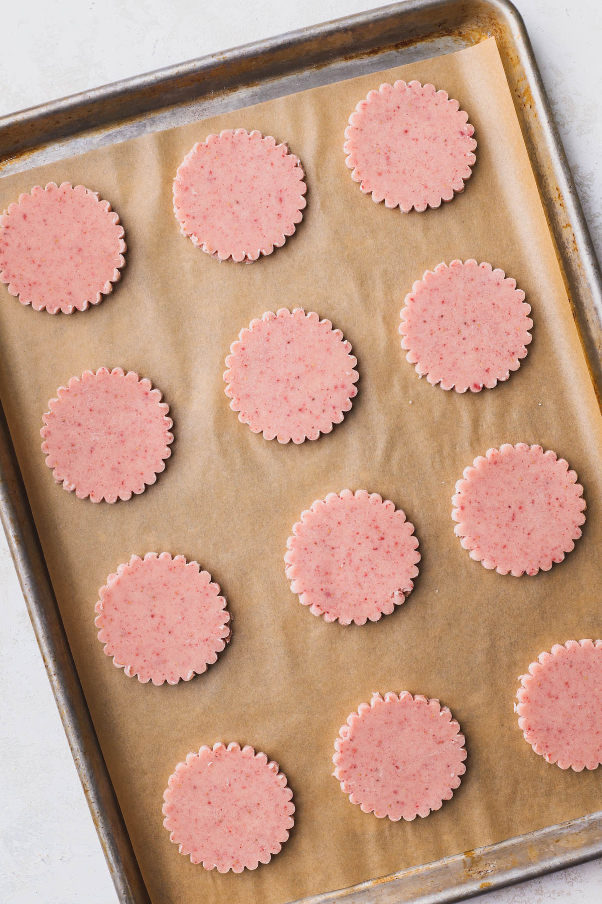Punched out strawberry shortbread cookies. 