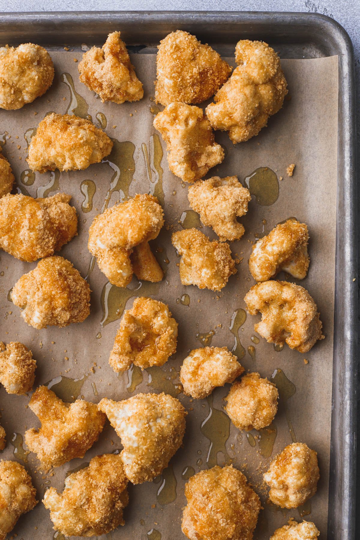 Cornflake coated cauliflower drizzled with olive oil.