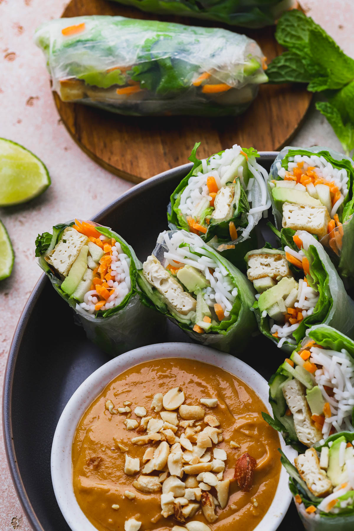 Summer rolls filled with tofu, vegetables, avocado, green apple, noodles and served with spicy peanut sauce. 