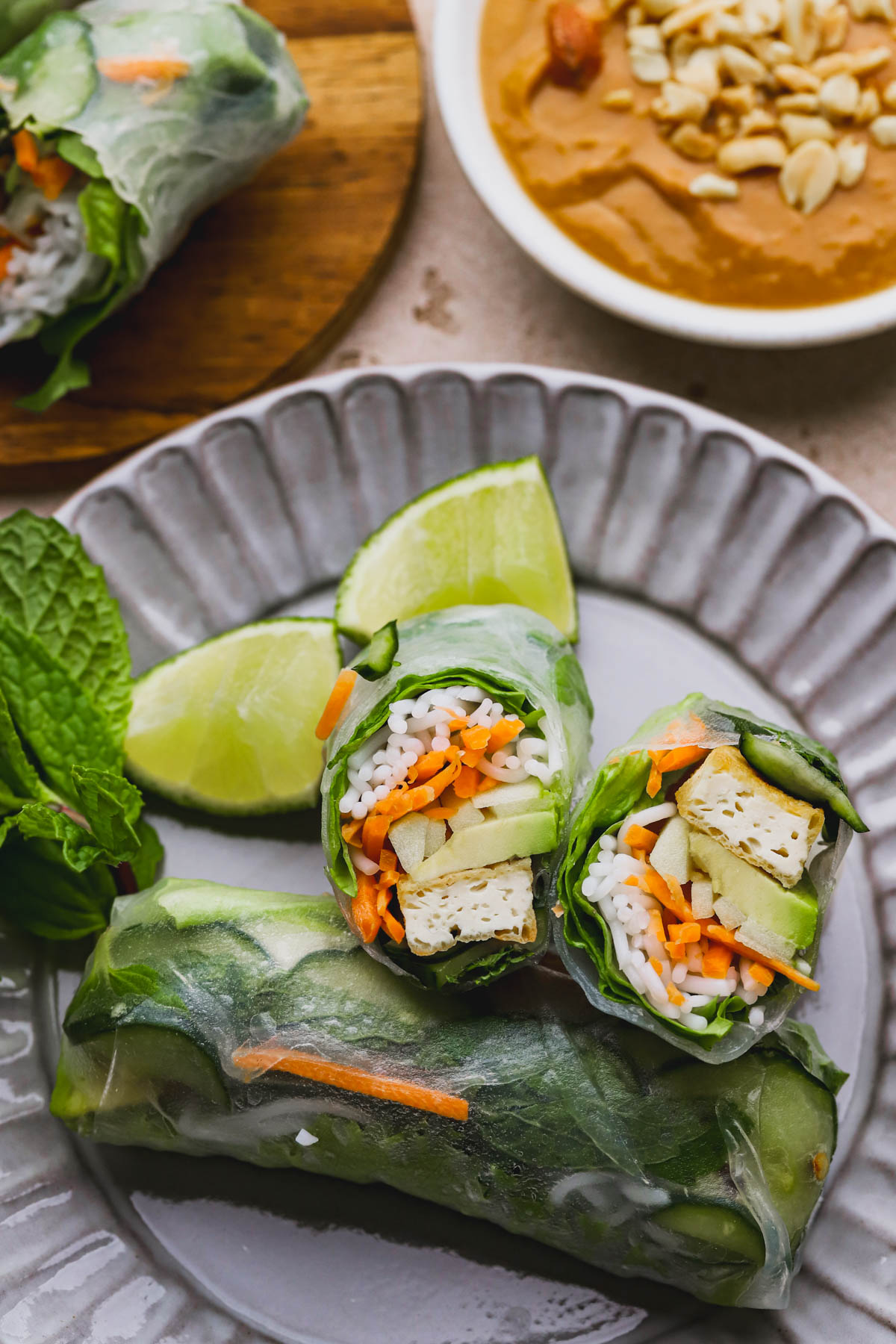 Summer rolls filled with rice noodles, vegetables, pickled cucumber, mint leaves and avocado.  