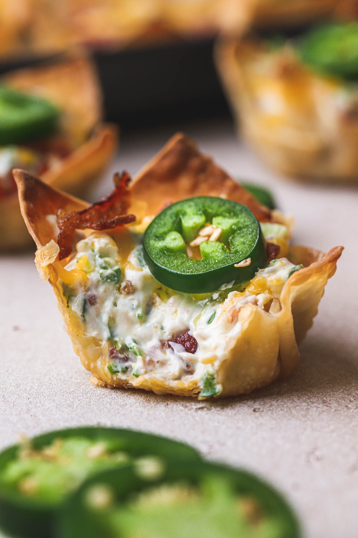 Crispy jalapeno popper wonton cups with bacon, cheddar cheese and cream cheese.  