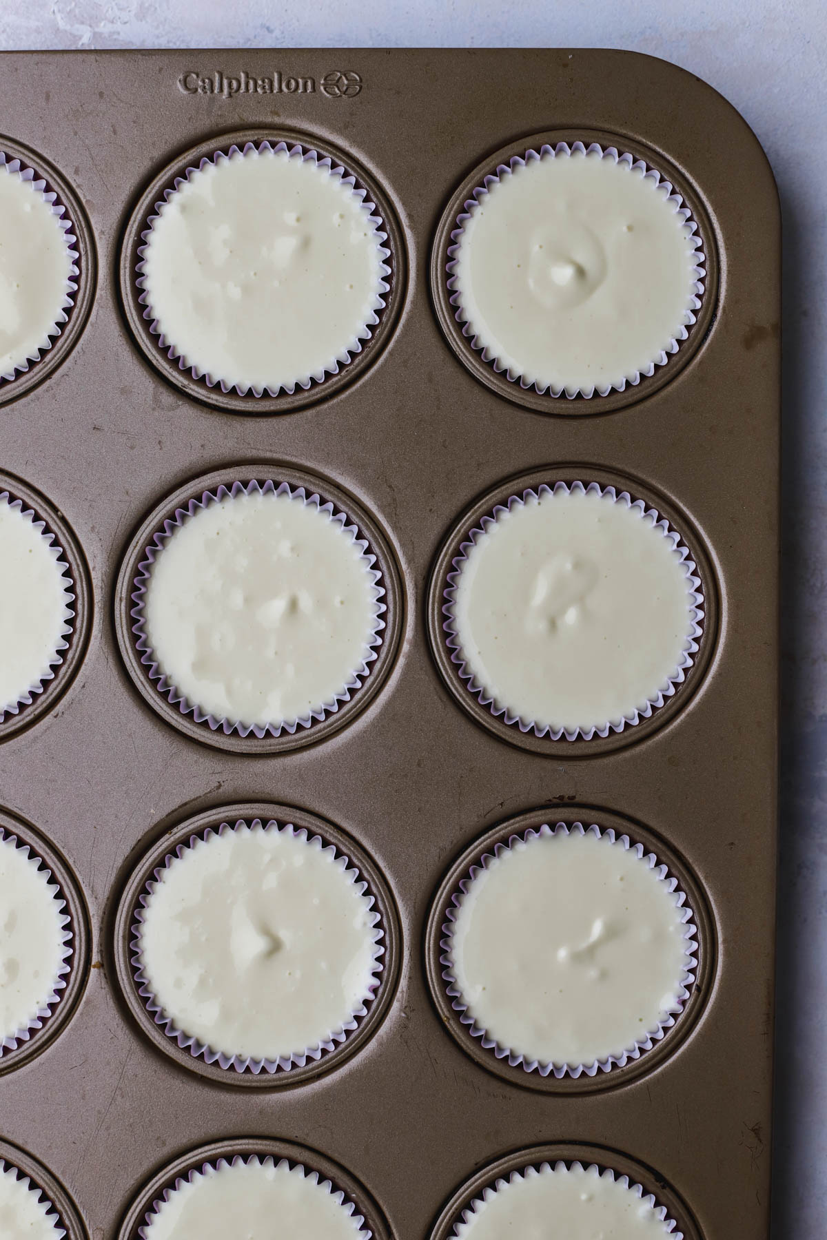 Vanilla cheesecake inside muffin mold.  