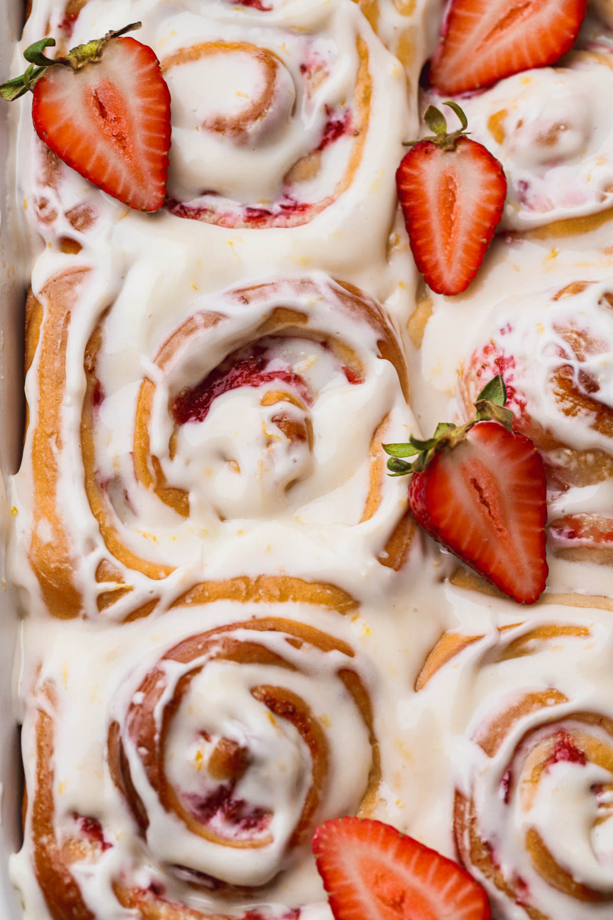 Strawberry rolls filled with strawberry jam and topped with lemon icing. 