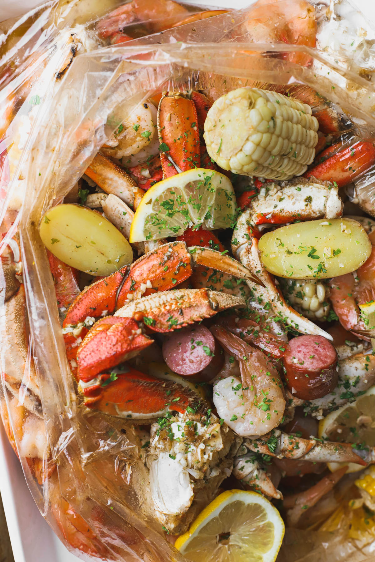 Seafood boil in a bag with crab, shrimp, sausage, and corn.  