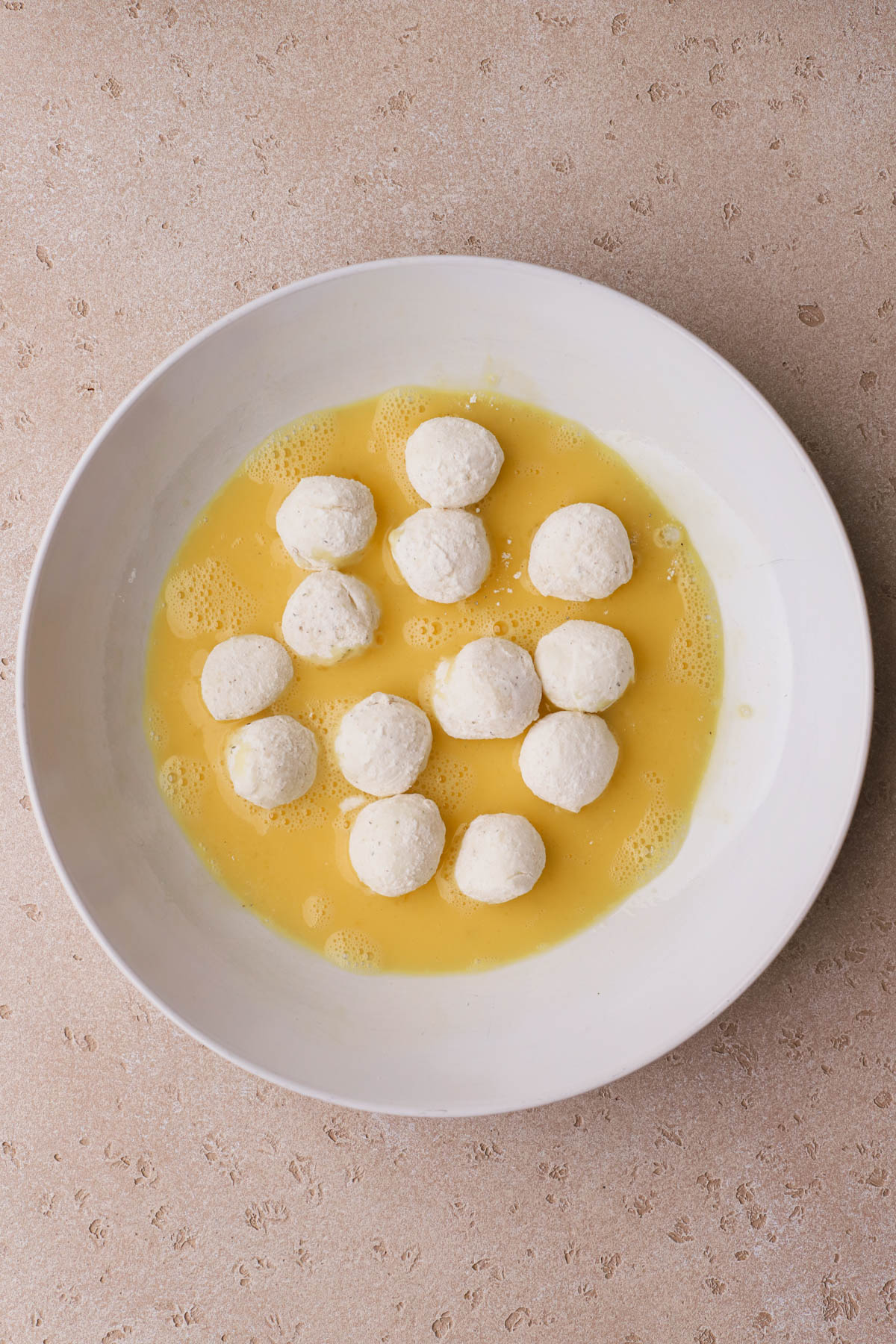 Mozzarella balls dipped in egg. 