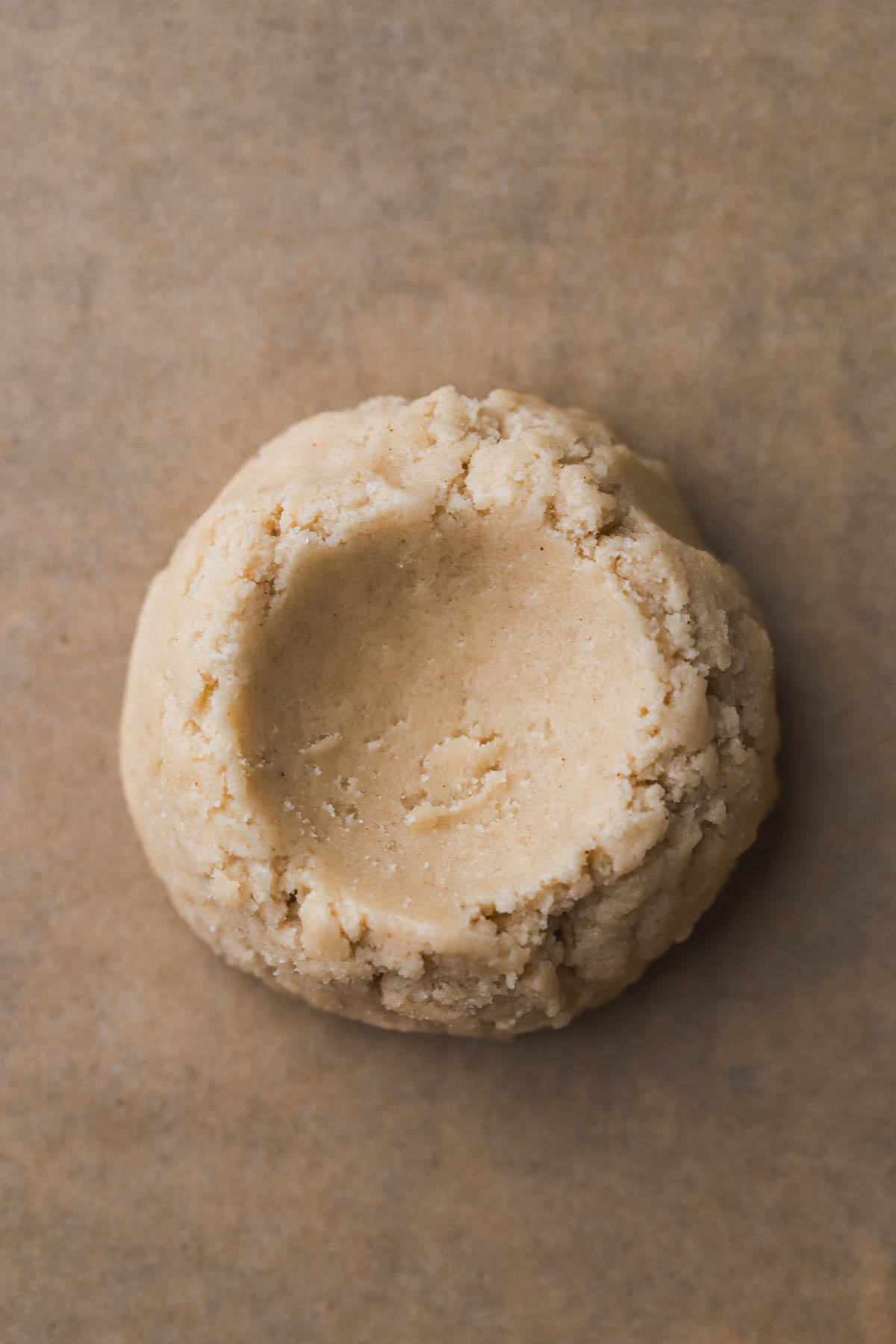 Scooped cookie dough with indentation in the middle.  