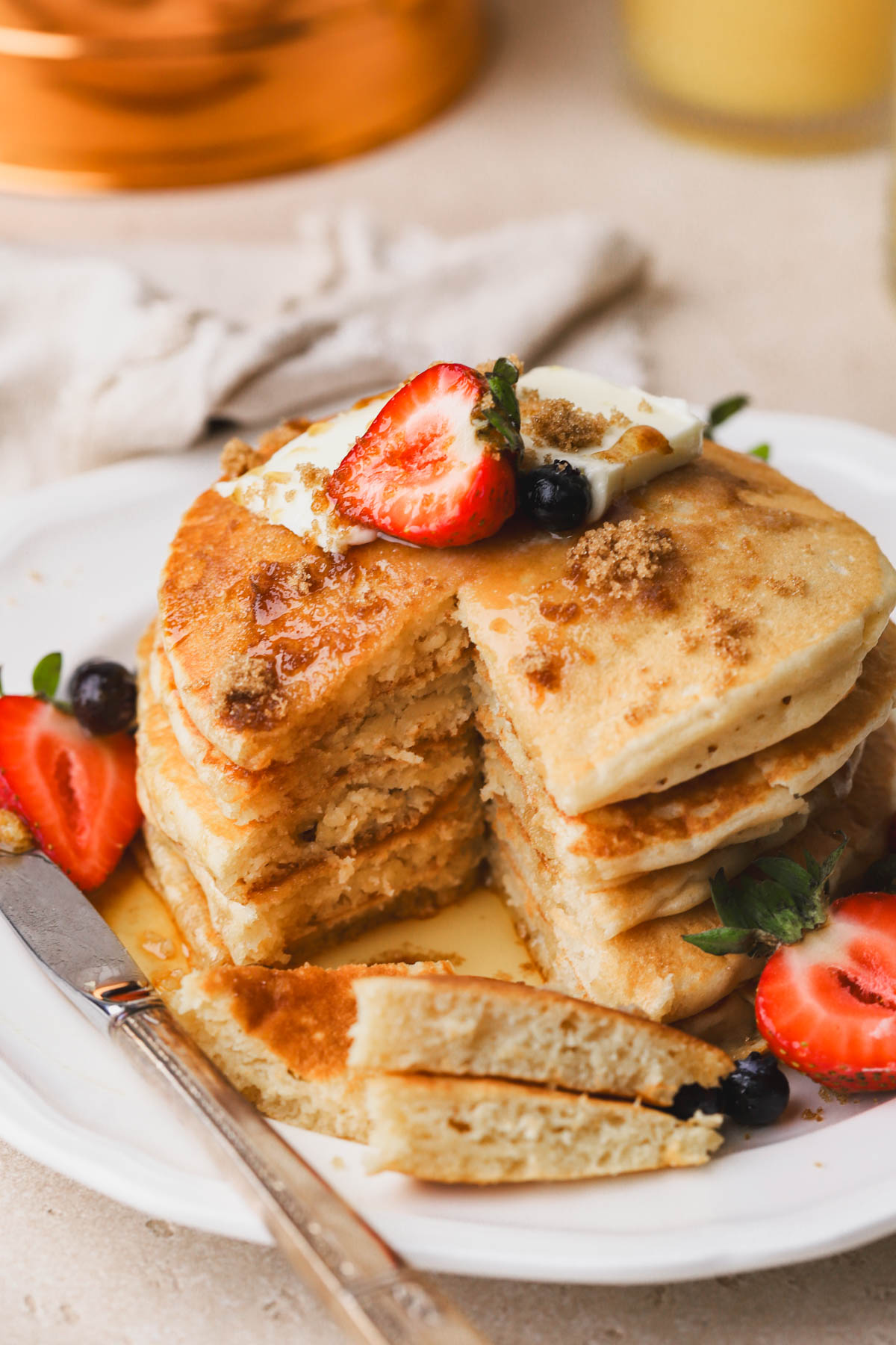 Pancakes with brown sugar, maple syrup, butter and berries. 