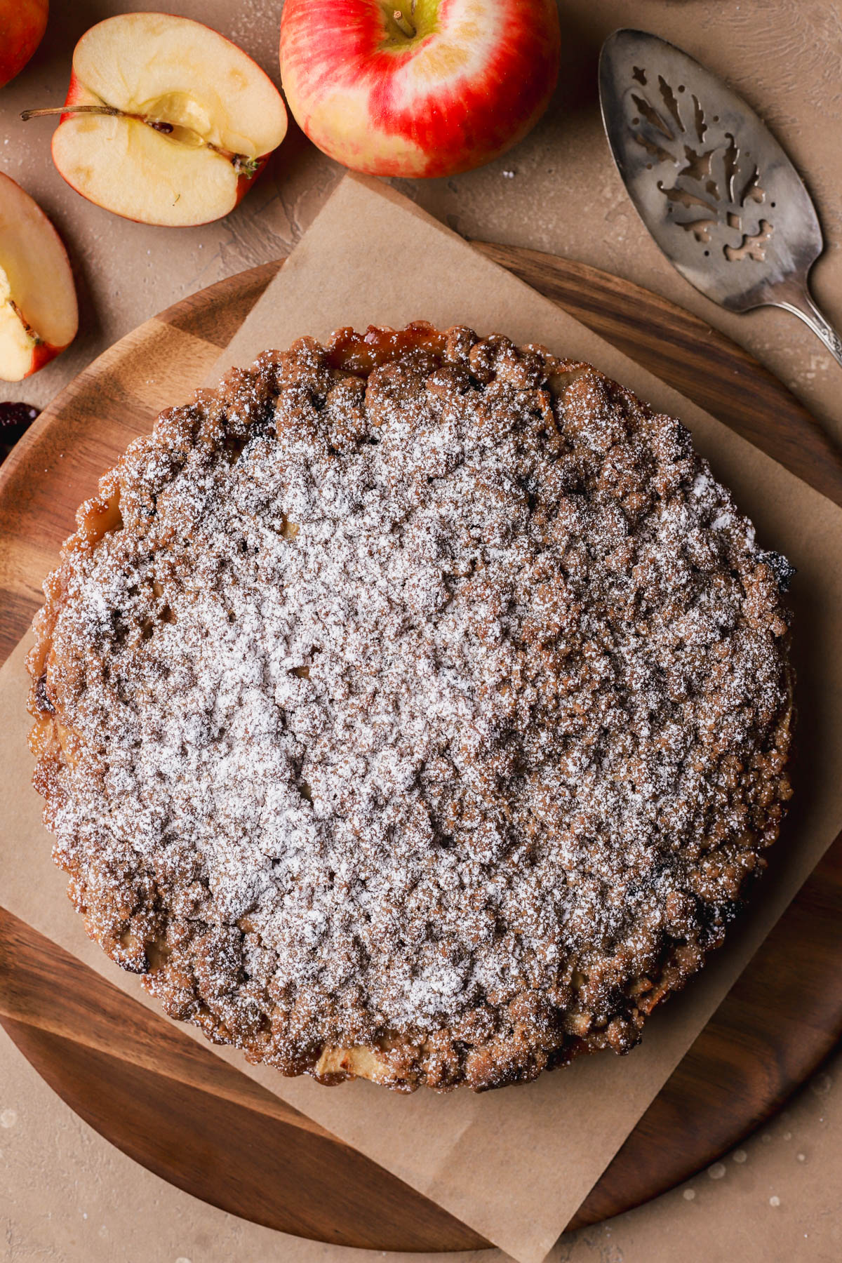 Baked apple crumble tart with powdered sugar.  
