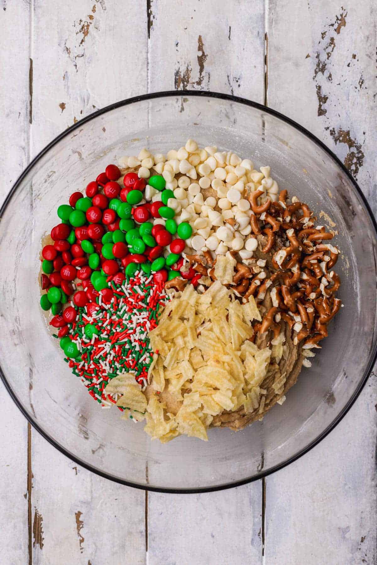 Cookie dough with M&M's, white chocolate chips, pretzels, potato chips and Christmas jimmies.