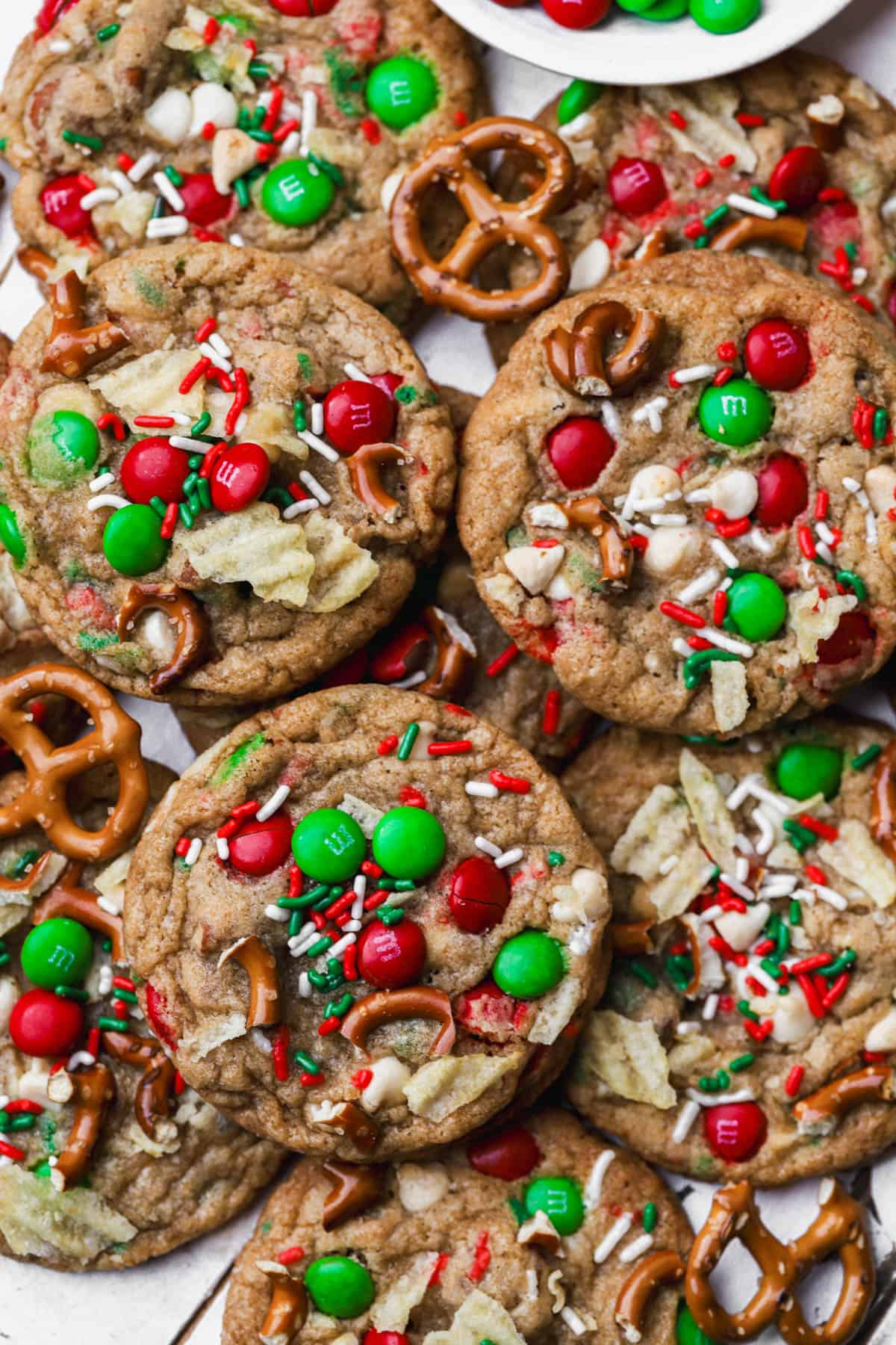 Baked cookies with holiday M&M's, pretzels, potato chips, sprinkles and white chocolate.