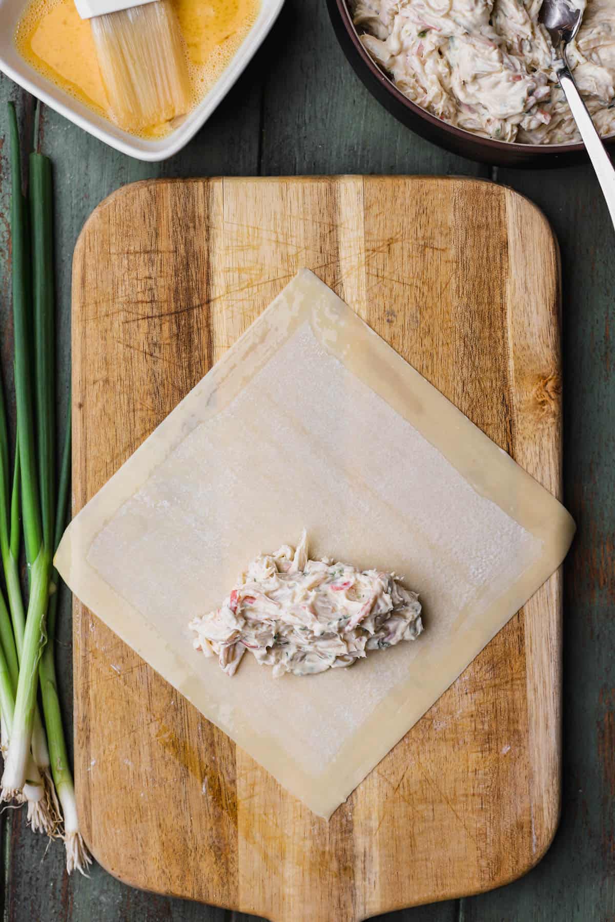 Crab rangoon filling inside egg roll.