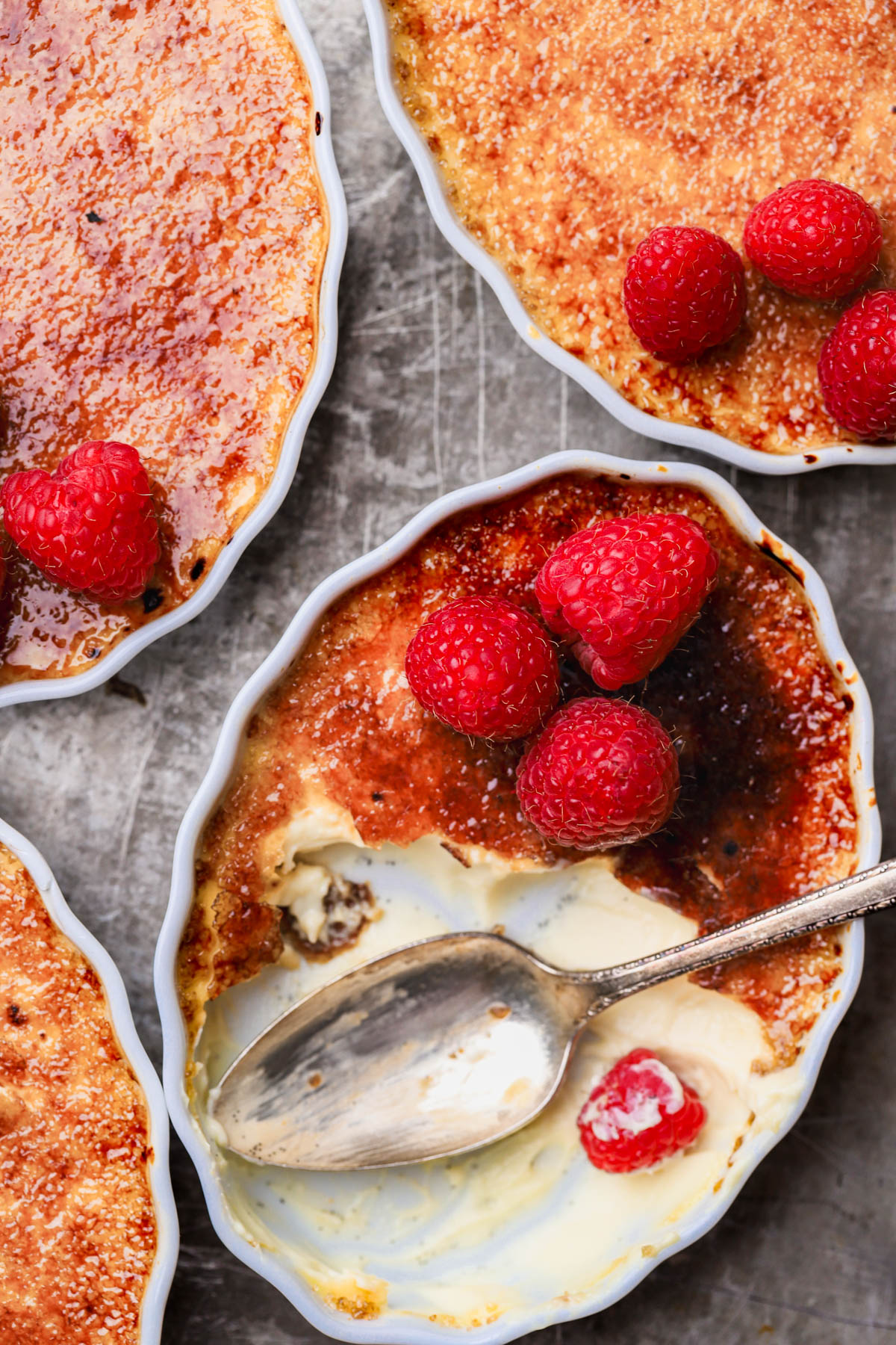 French creme brûlée with crackly sugar and raspberries. 