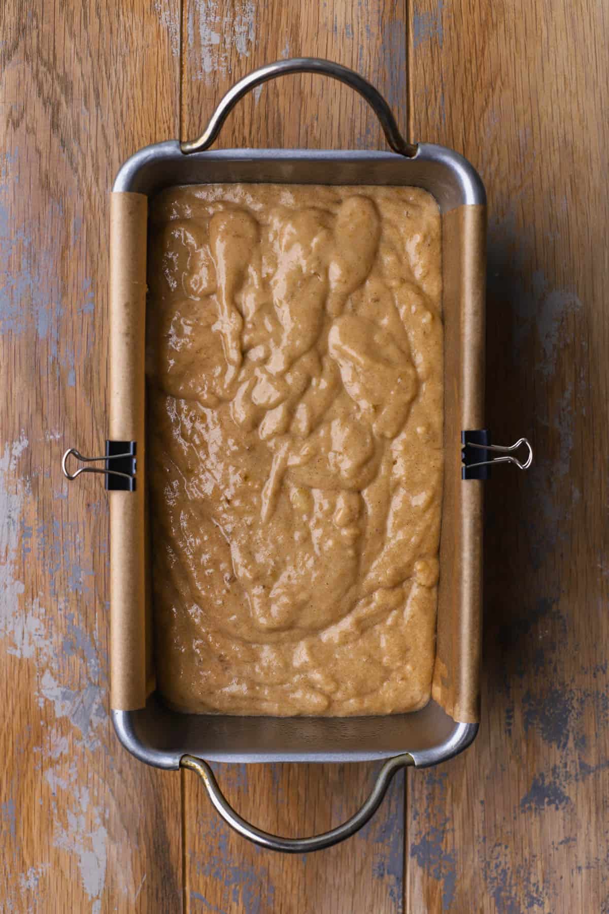 Banana bread batter inside loaf pan. 