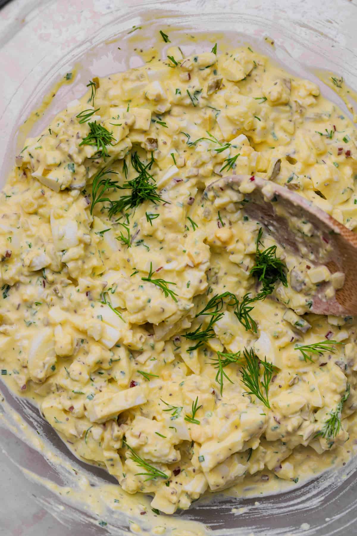 Creamy egg salad with dill pickles and fresh dill.