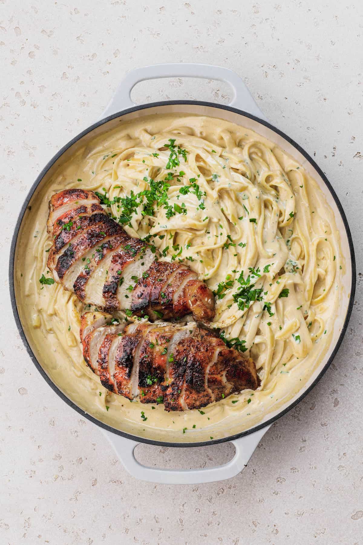Seared chicken with alfredo sauce and fettuccini.  