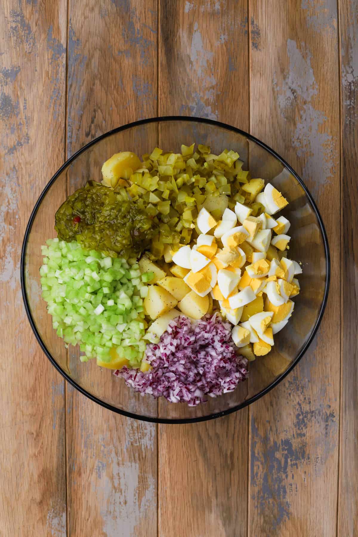 Gold potatoes, celery, onions, hard boiled eggs, pickles and relish. 