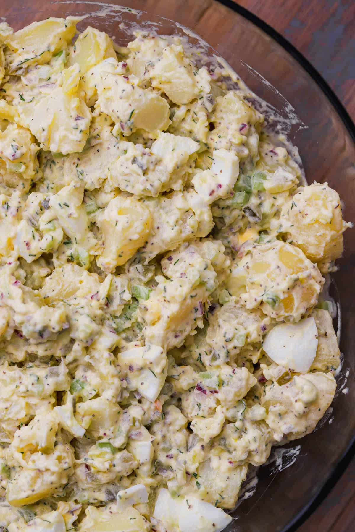 Dill pickle potato salad with hard boiled eggs, onions celery, and fresh chopped dill. 