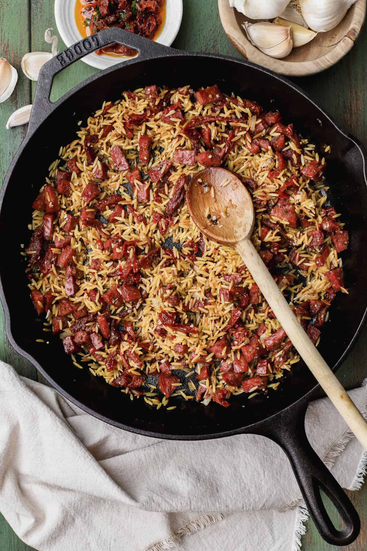 Sun-dried tomatoes, orzo, chorizo, onions, garlic.