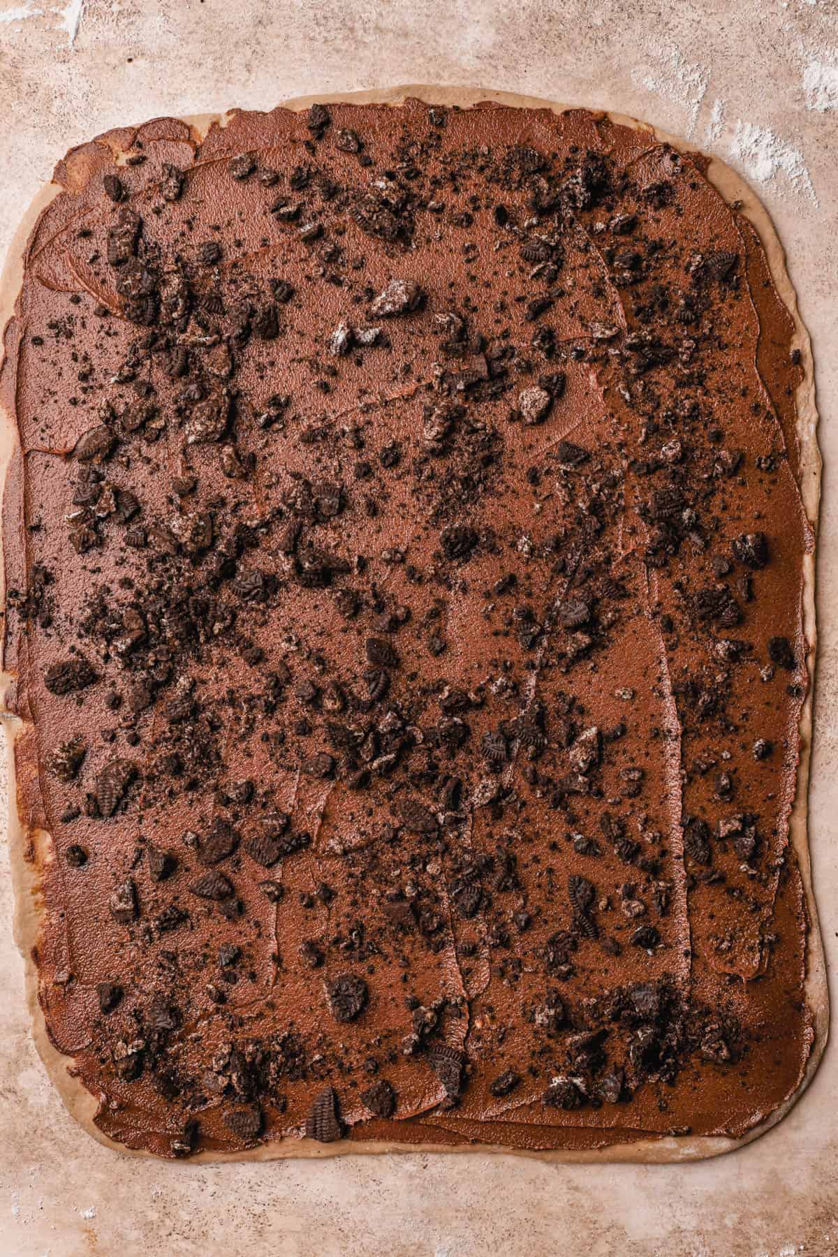 Rolled dough with cinnamon filling and crushed Oreo cookies.