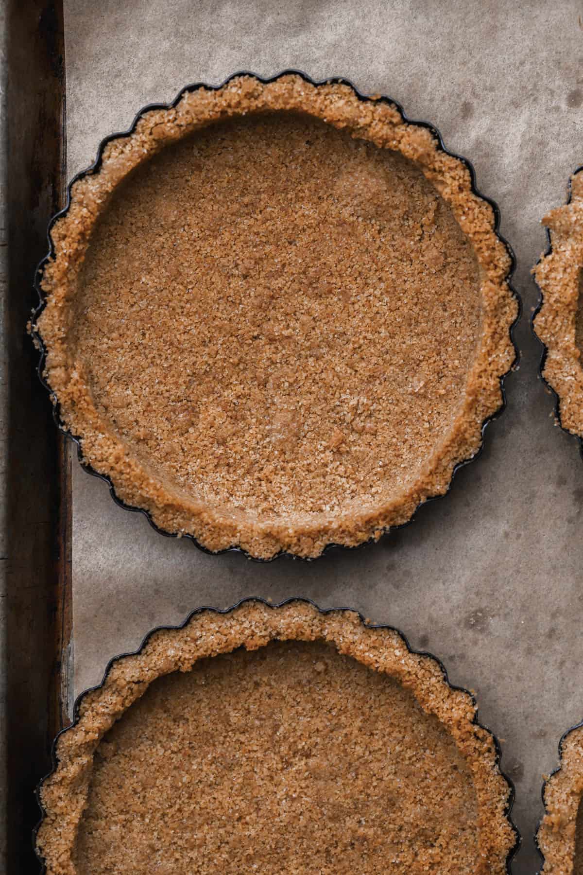 Baked graham cracker tart shells.