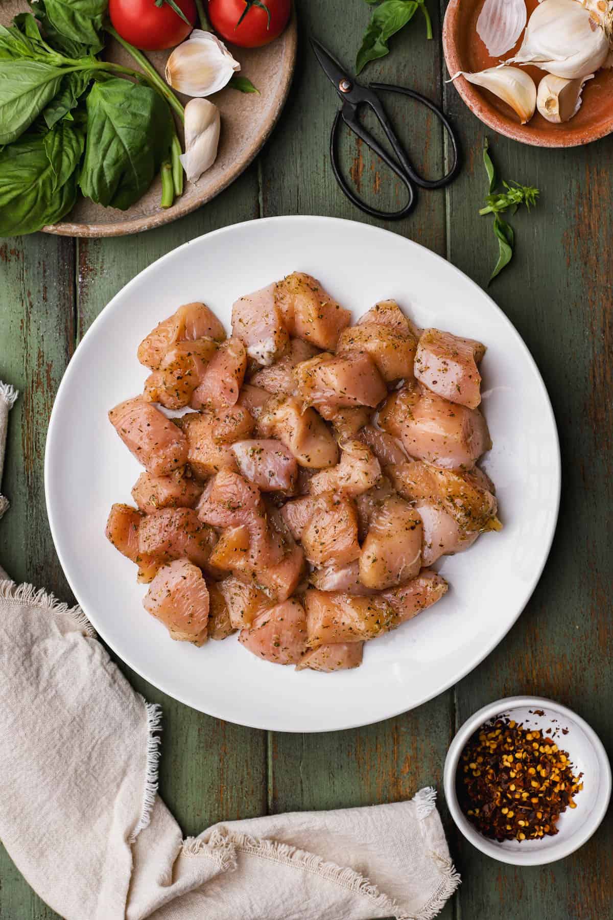 Raw seasoned chicken breast cut into small cubes.  