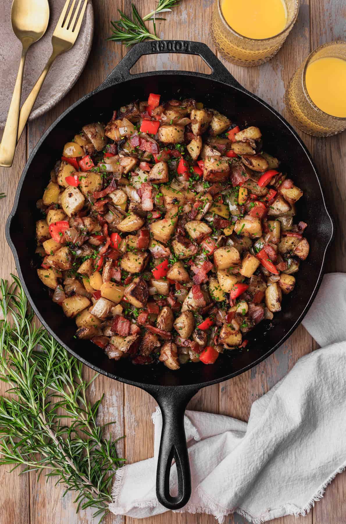 Breakfast potato hash with bell peppers, rosemary, bacon, onions and chives.