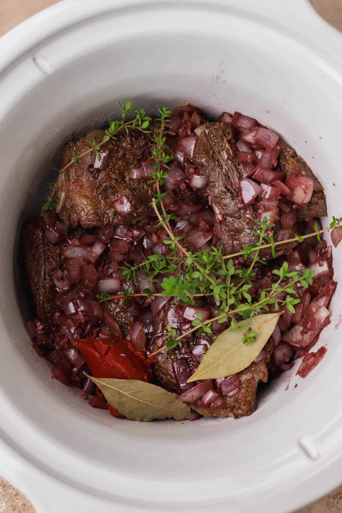 Short ribs, garlic, onions, tomato paste, red wine, bay leaves and fresh thyme.
