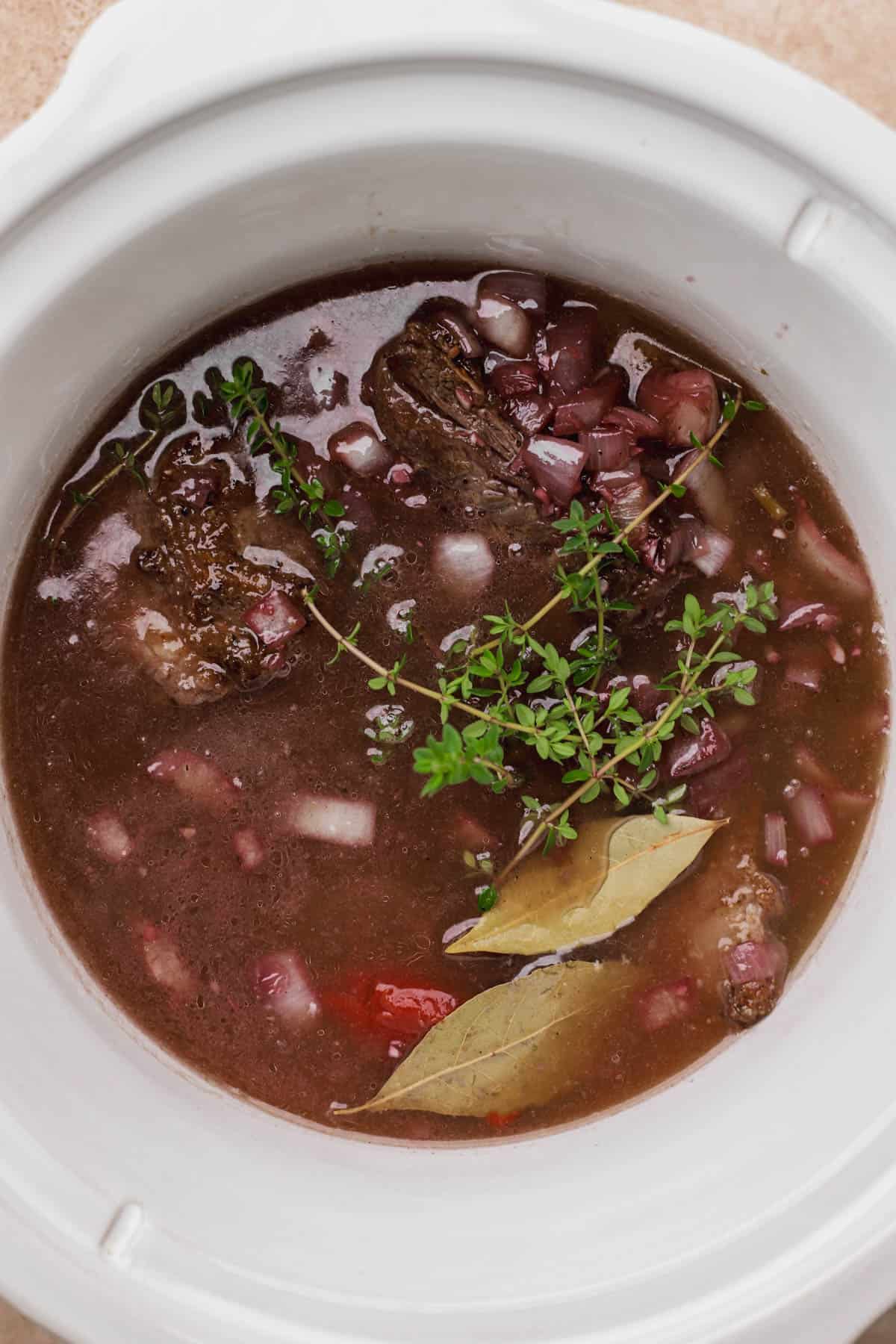 Short ribs, garlic, onions, tomato paste, red wine, bay leaves, fresh thyme and beef stock.