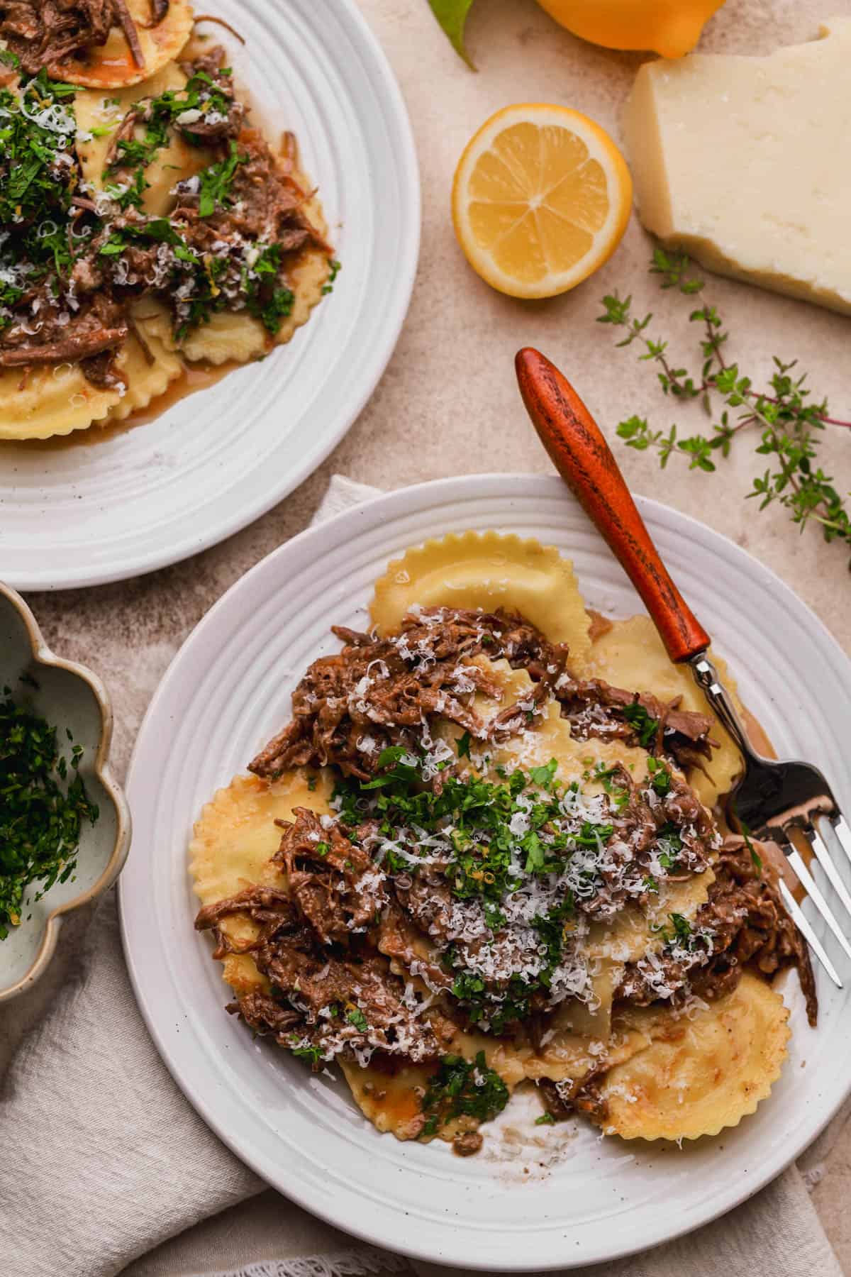 Short rib ravioli with gremolata and parmesan cheese.