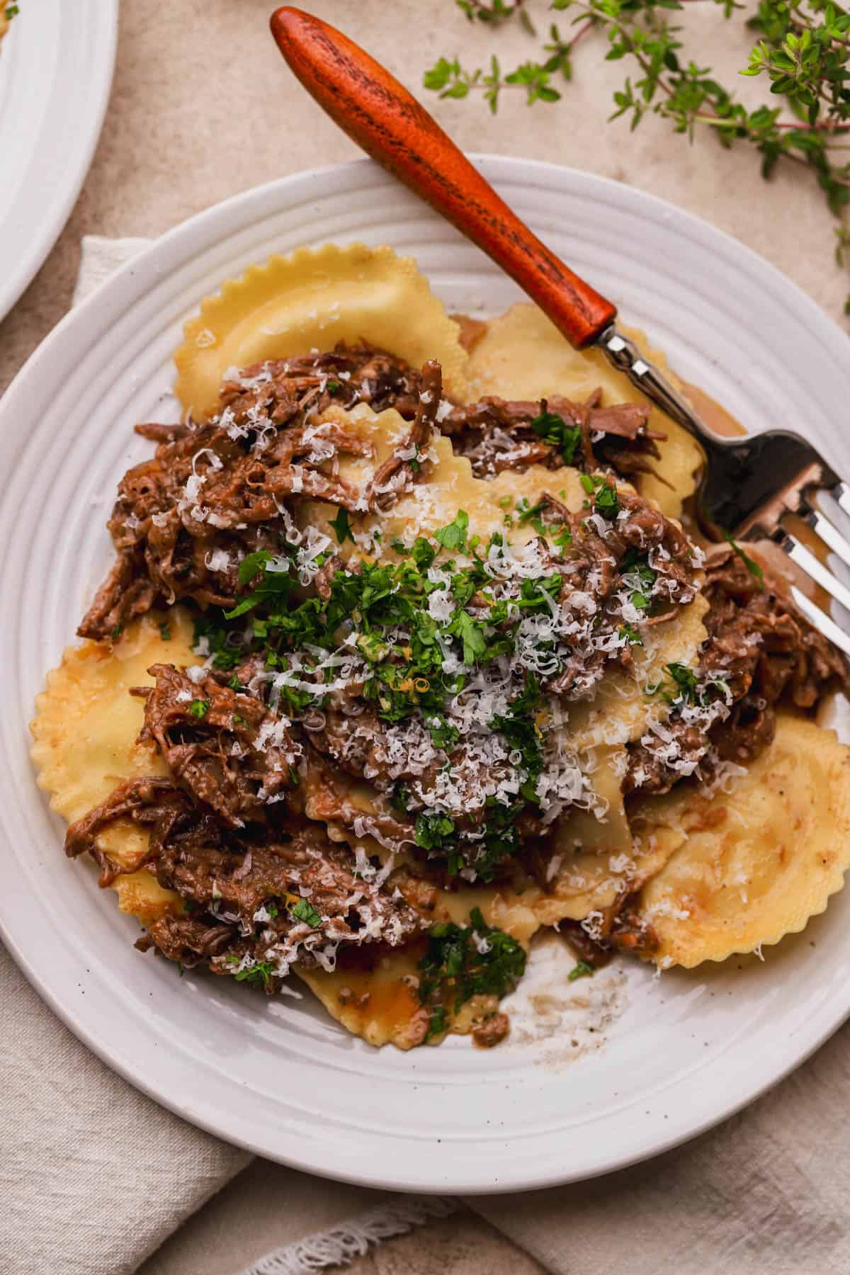 Short rib ravioli with parmesan cheese and gremolata.