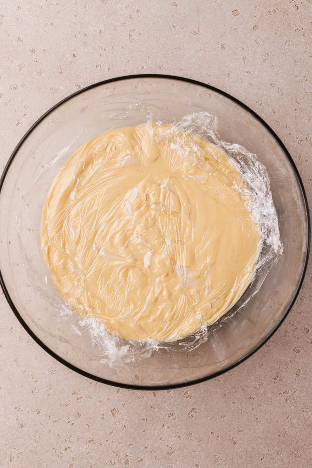 Vanilla custard covered with plastic wrap. 