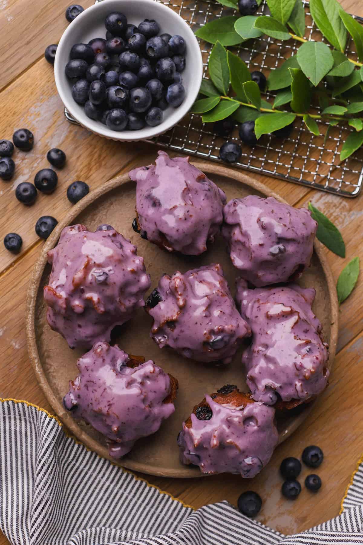Blueberry fritters are made with fresh blueberries, cinnamon and dipped in a homemade blueberry glaze.