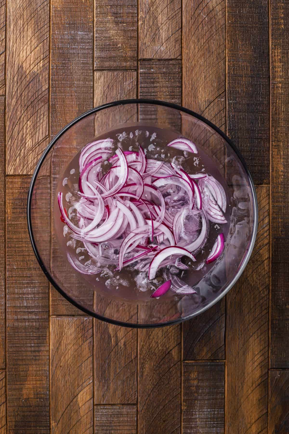 Red onions in ice water.