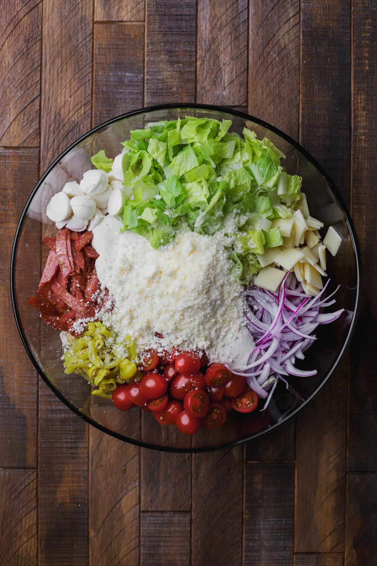 Rotini pasta, creamy dressing, tomatoes, provolone, mozzarella, peperoncini, salami, romaine lettuce pepperoni and parmesan cheese.