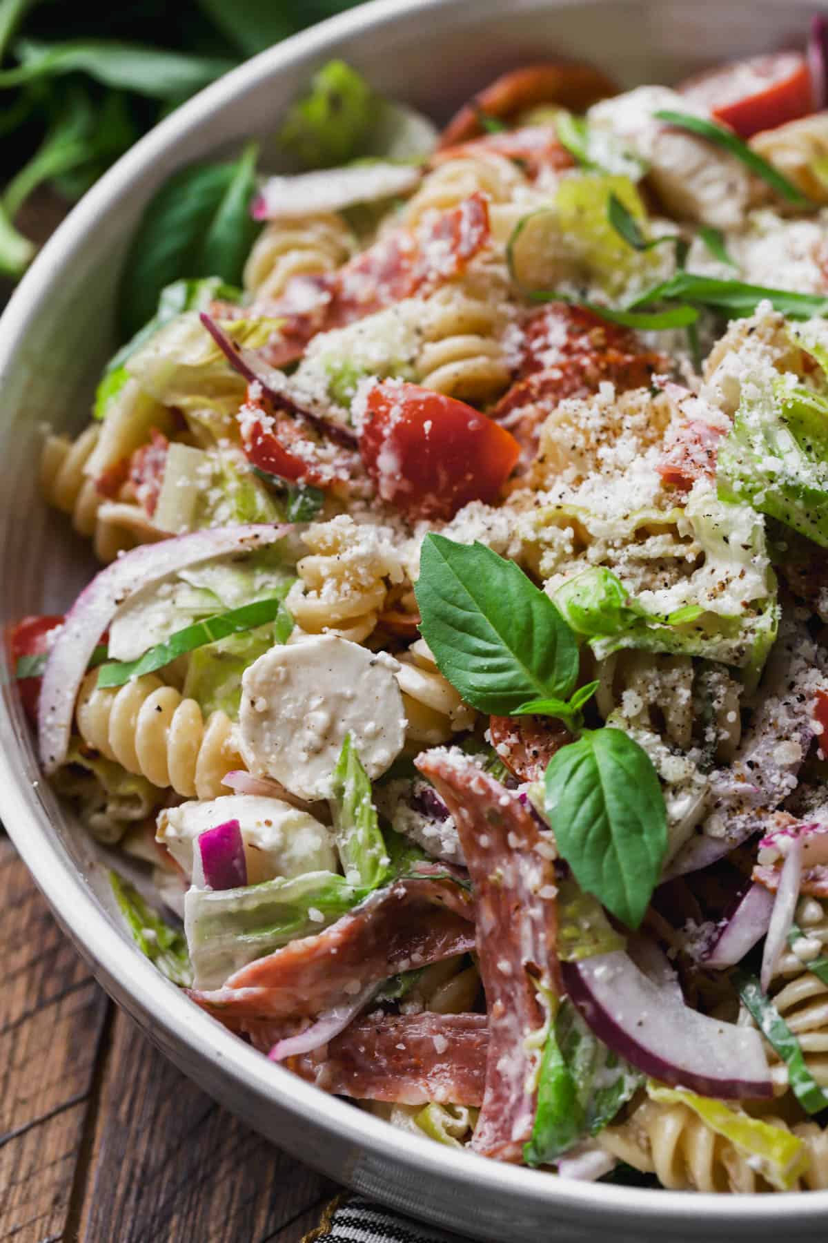 Grinder pasta salad with cured meats, cheese, lettuce, basil, creamy dressing and red onions.