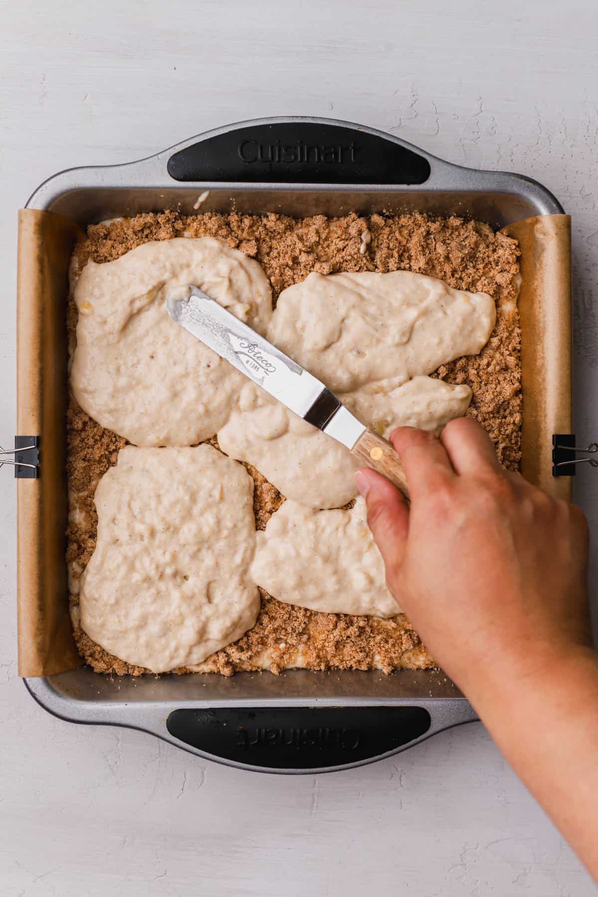 Banana batter spread over streusel filling. 