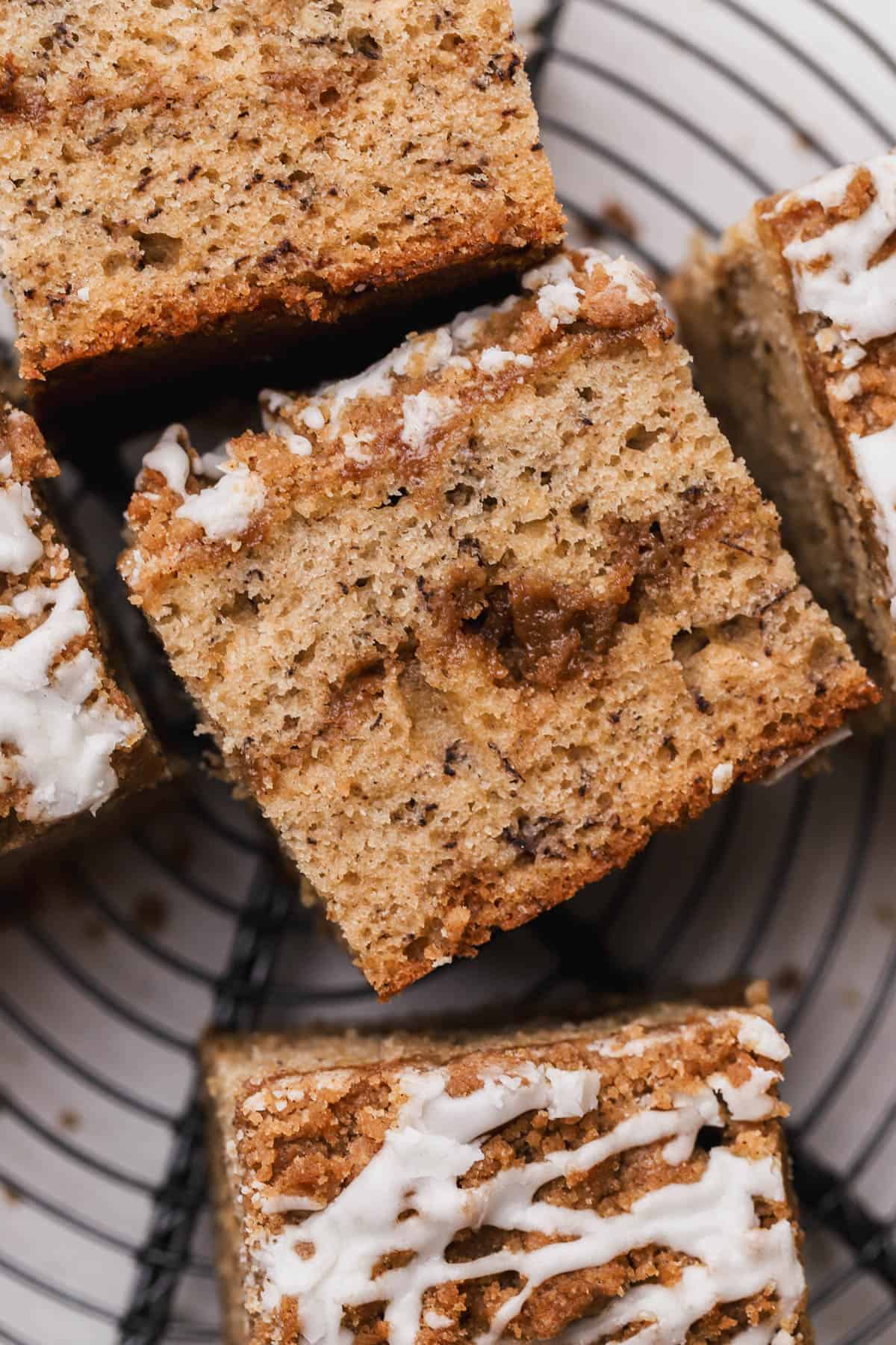 Banana cake filled and topped with cinnamon streusel and vanilla icing. 