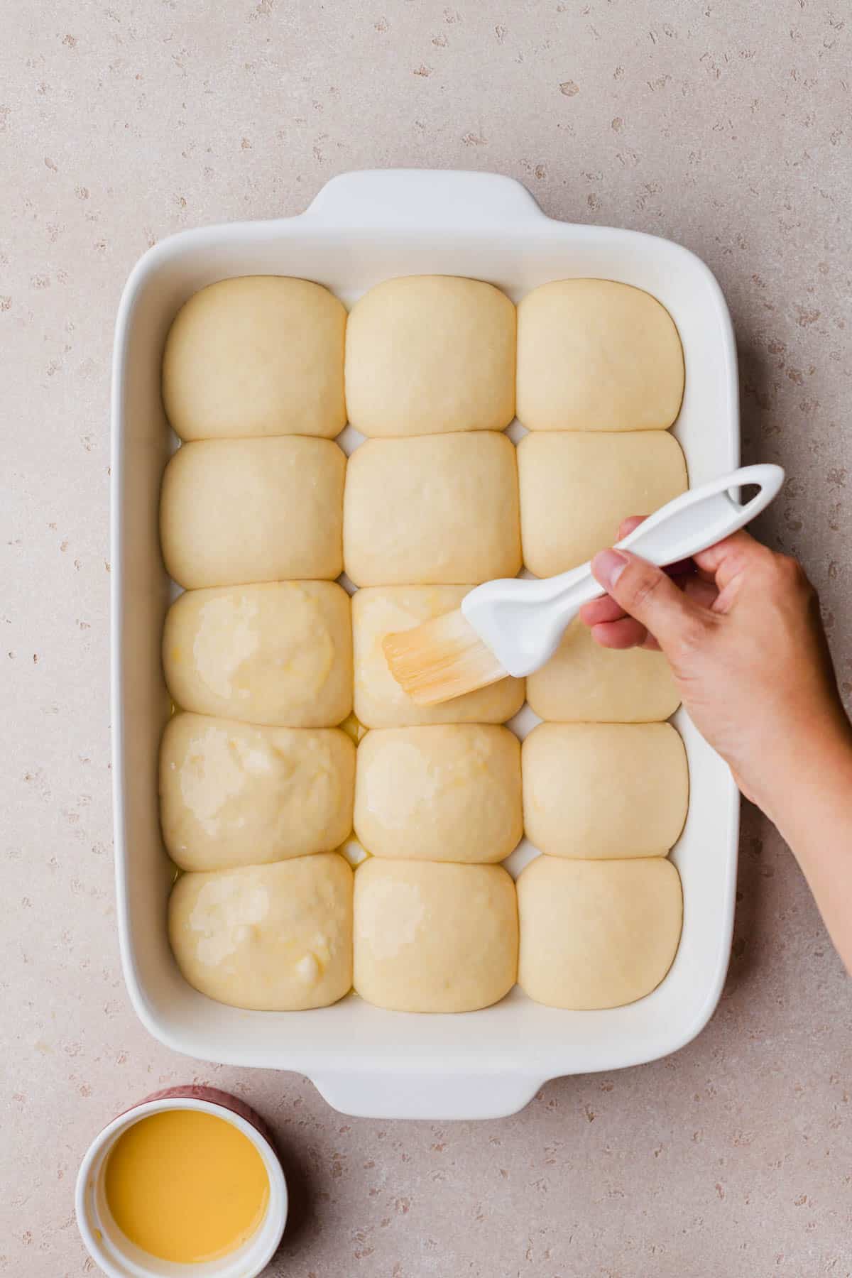 Risen dough rolls brushed with egg wash. 