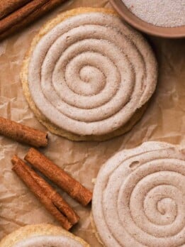 Churro cookies with cinnamon buttercream swirls and cinnamon sugar sprinkled on top.