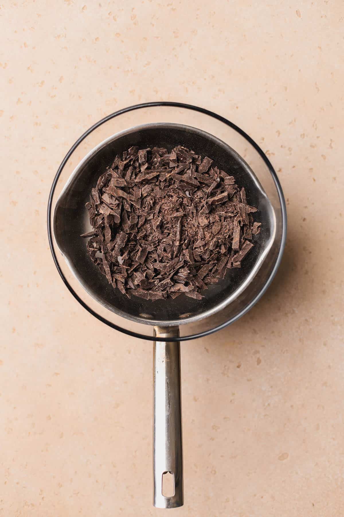 Chopped chocolate placed over double boiler.  