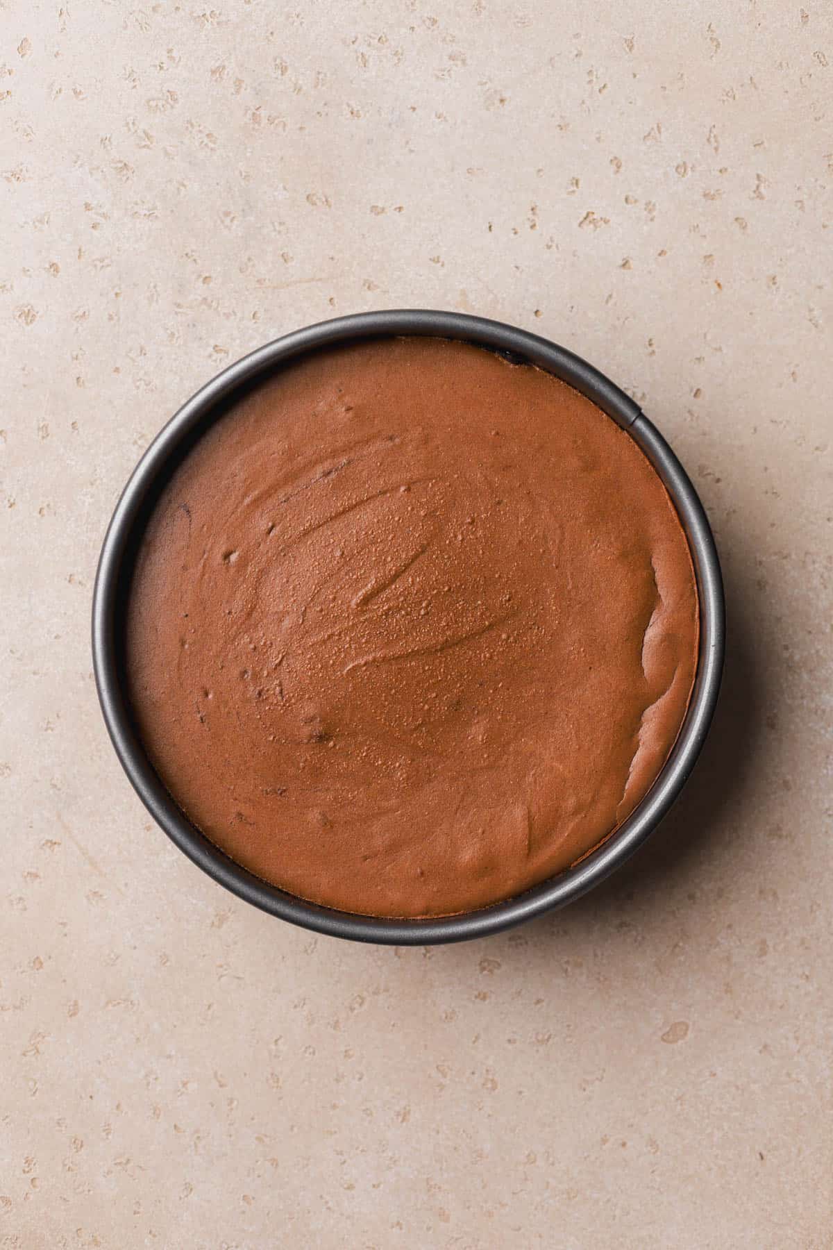 Baked and cooled chocolate cheesecake. 