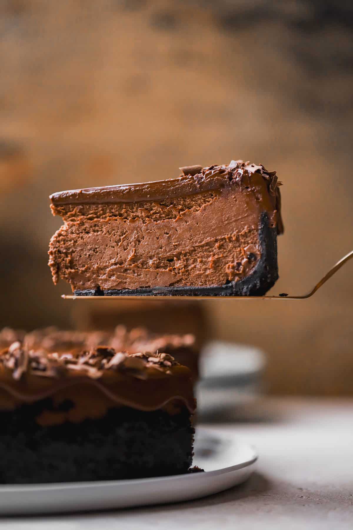 Chocolate ganache cheesecake with Oreo cookie crust and chocolate shavings on top. 