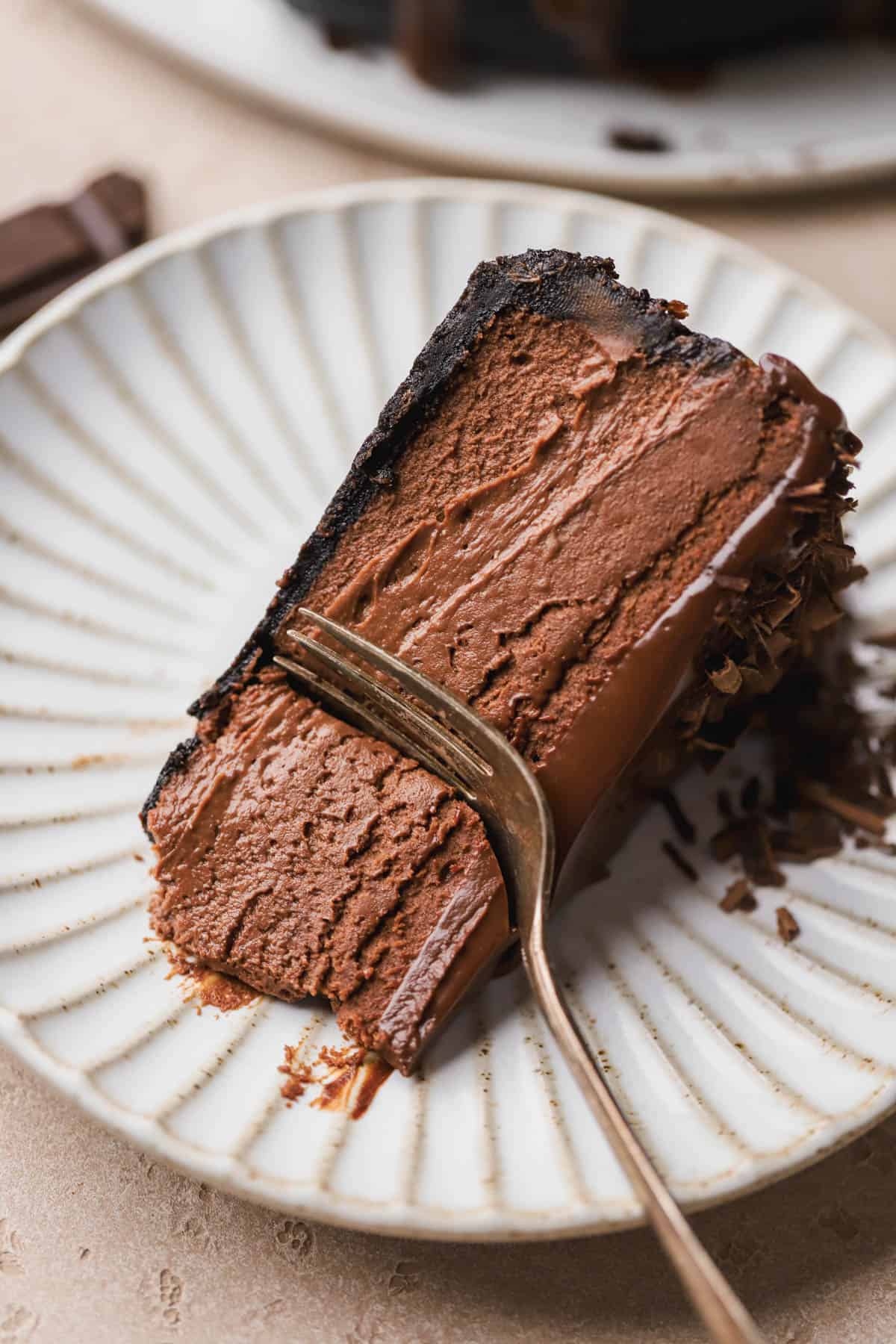 Sliced chocolate cheesecake with Oreo crust and ganache topping. 