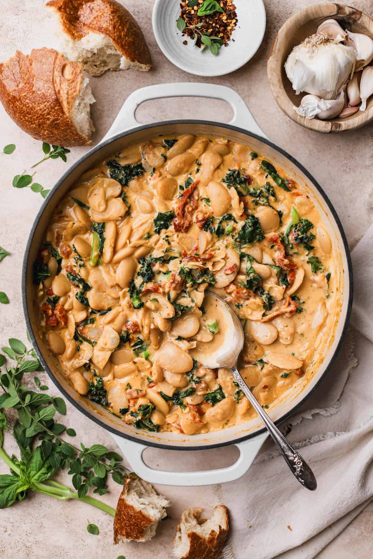Marry me beans are made with butter beans, garlic, red chili flakes, basil, sun-dried tomatoes, kale, heavy cream and parmesan cheese. Served with crusty bread.